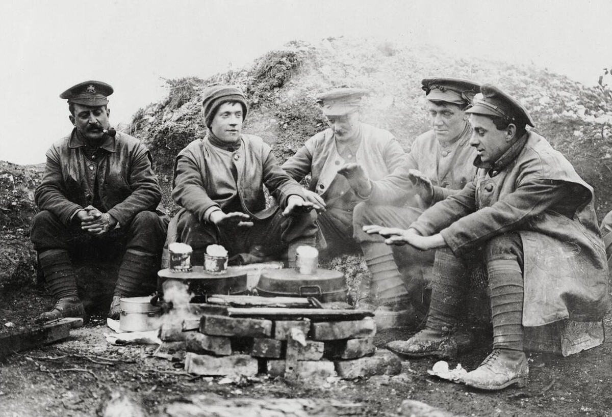 British soldiers keeping warm while waiting for lunch in France, 1914