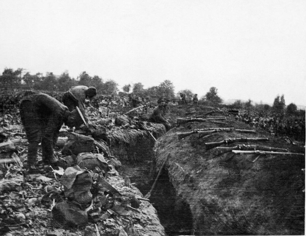 British troops drying their kits and draining a trench during a dry spell, 1915