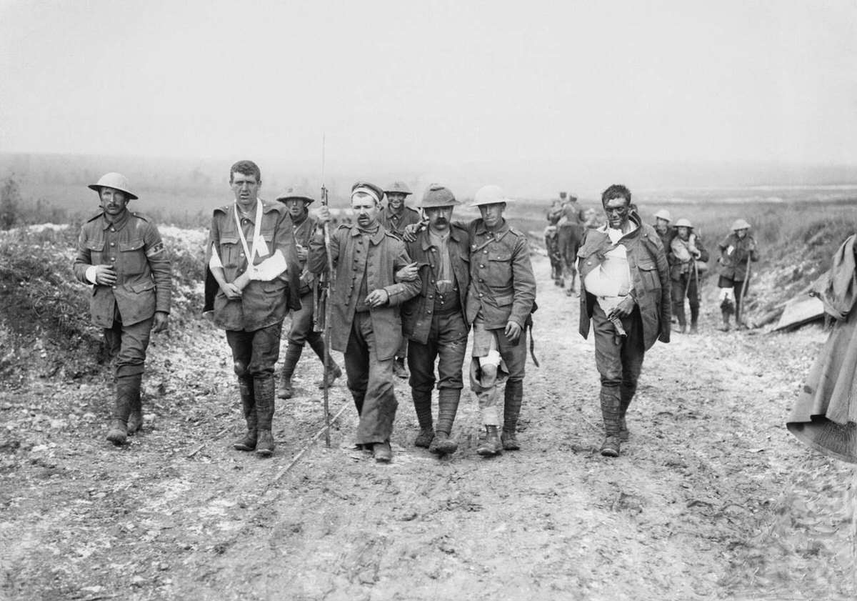 German prisoner helping British wounded to a dressing station near Bernafay Wood, 1916