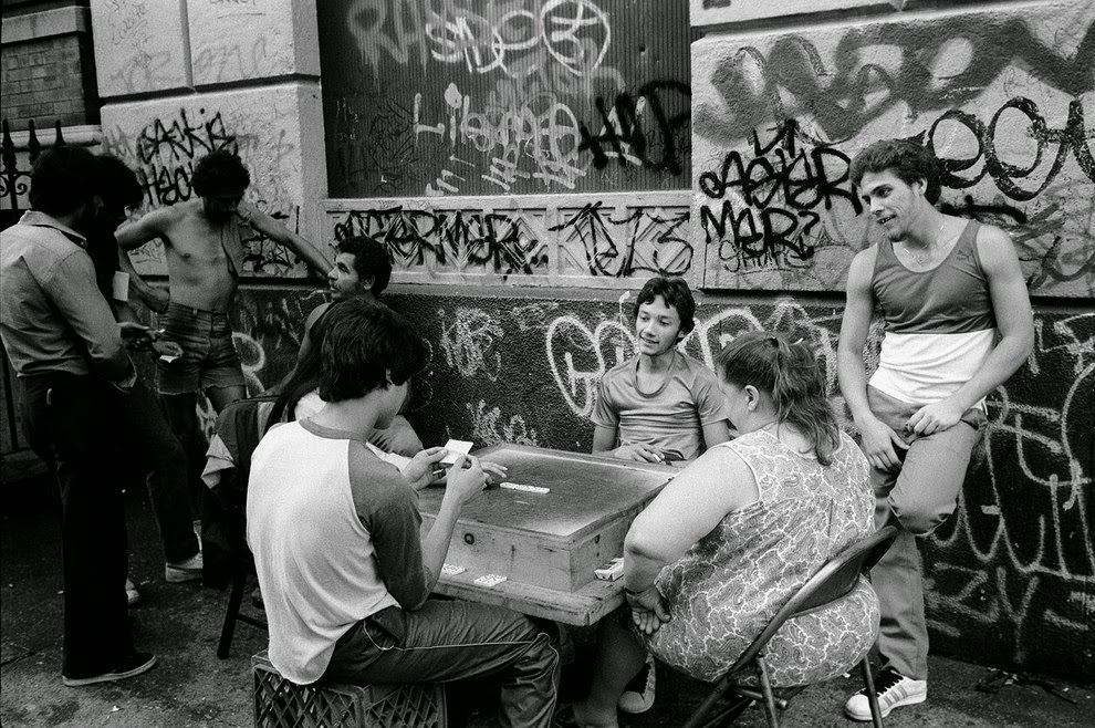 Teenage boys and adults play dominoes, 1985.