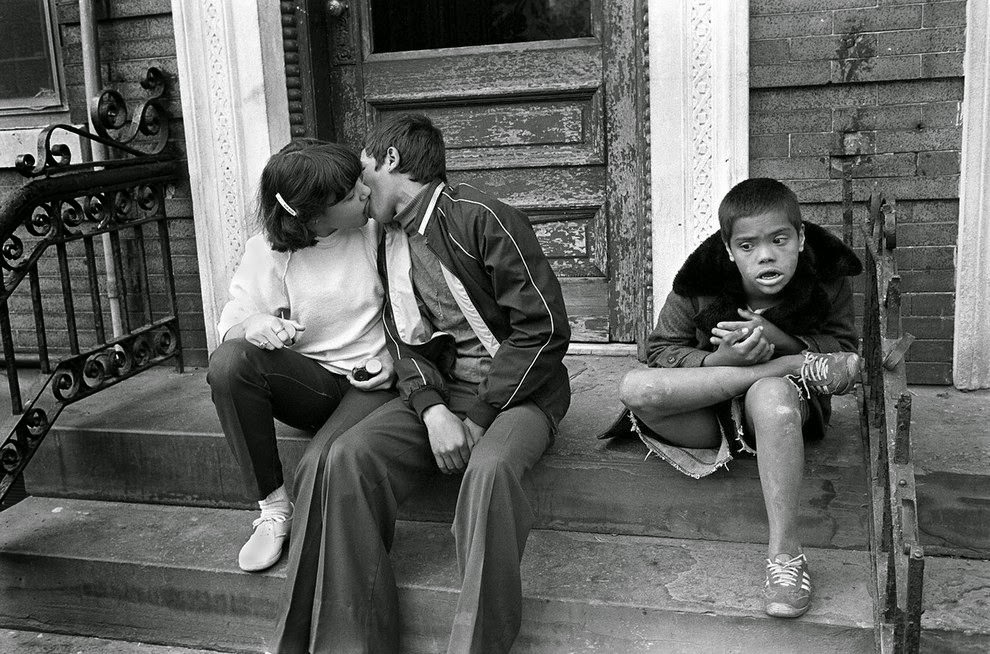 Teenage couple kisses on steps, 1982.