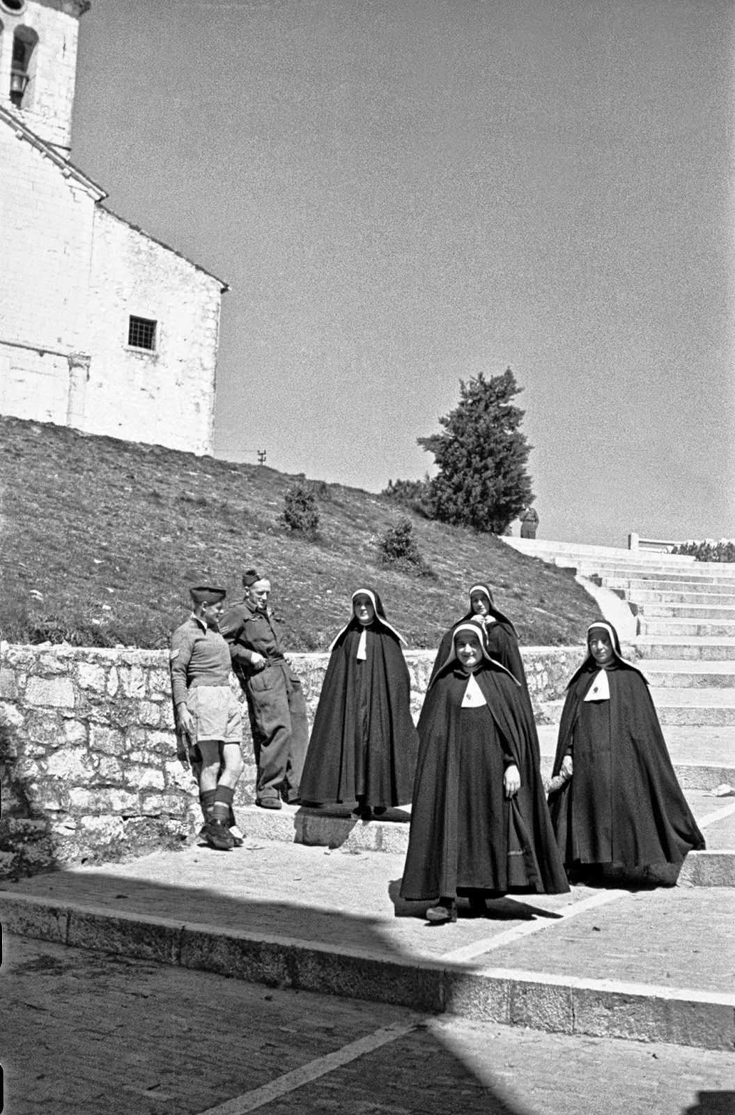 A Graham and R J Richardson watch passing nuns on steps leading to Campobasso castle.