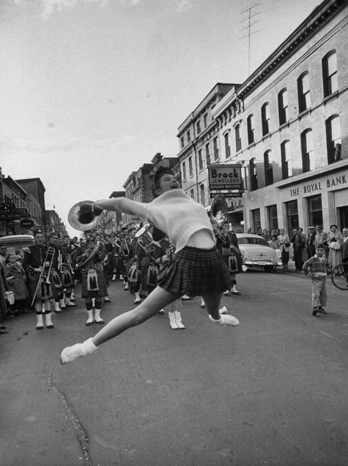 Gail Thorson soars off the street as she leads victory procession through Kingston.