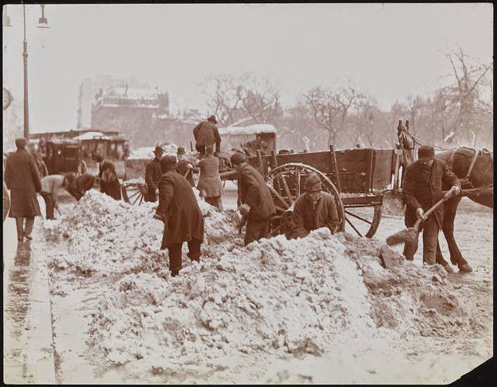 Workers carting snow on a street near Madison Square, 1898