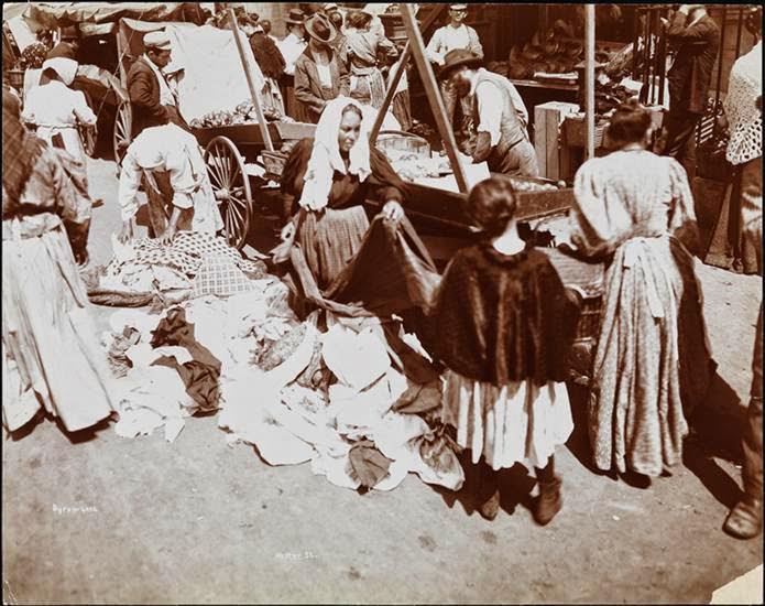 Women shopping for clothes stacked on the ground on Hester Street, 1898