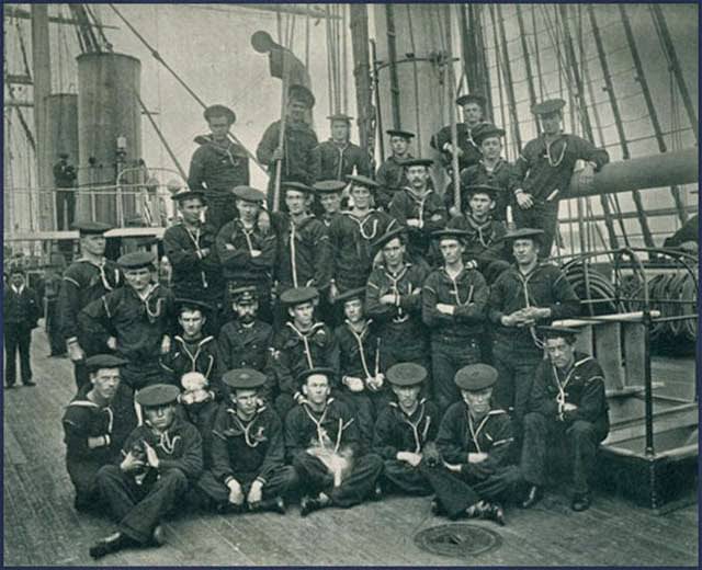 Apprentices aboard the USS Pensacola pose with mascot cat and dogs in February 1888. The Pensacola was a screw steamer that participated in Admiral David Farragut's capture of New Orleans in 1862.