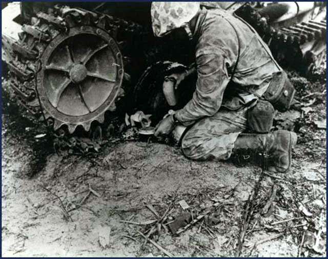 After the smoke of battle had cleared on Betio Island, Tarawa, this tiny kitten crept out from beneath a wrecked Japanese tank, to receive a drink from a U.S. Marine. Tawara Invasion, November 1943.