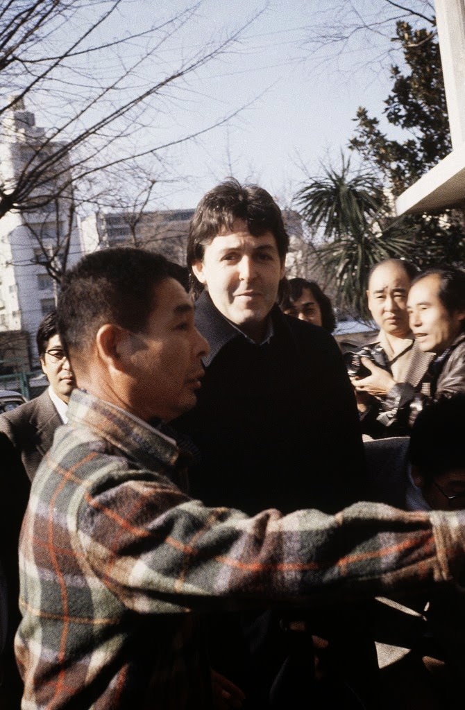 Former Beatle Paul McCartney is rushed from a police car to a drug investigation unit in Tokyo after spending a night in jail on Jan. 17, 1980. He was arrested at Tokyo’s Narita Airport after customs officers found marijuana in his luggage.