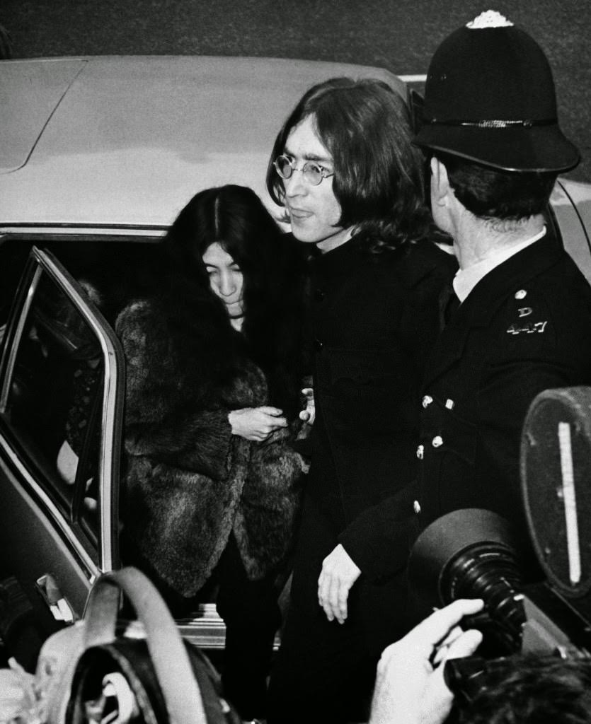John Lennon, one of the Beatles, and his Japanese girl friend, Yoko Ono, leave car to enter Marylebone court in London on Oct. 19, 1968. They appeared on charges of possessing cannabis, the British name for hashish. The trial was set for late November after the police asked for time to have the seized drugs analyzed.
