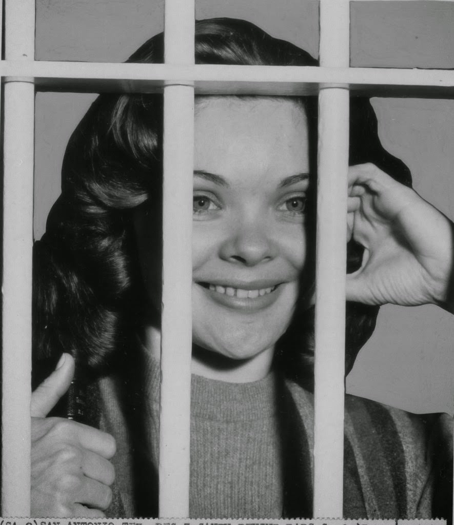 Burlesque dancer Candy Barr, went behind bars after turning herself in to Bexar County Sheriff near noon, Thursday, Dec. 3, 1959, San Antonio, Texas.