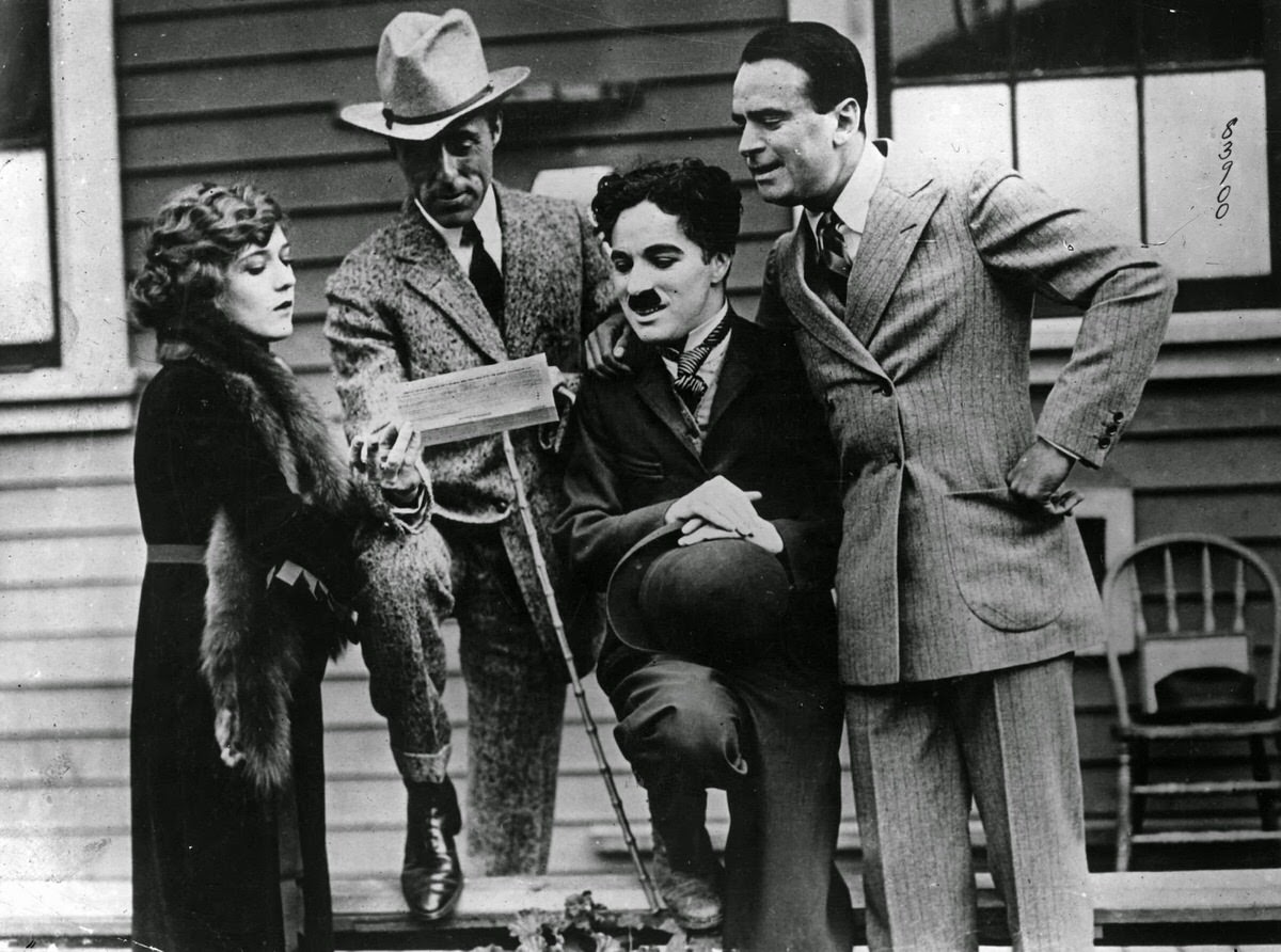 Charlie Chaplin with actress Mary Pickford, actor Douglas Fairbanks, and film director D.W. Griffith on the day they formed United Artists in 1919.