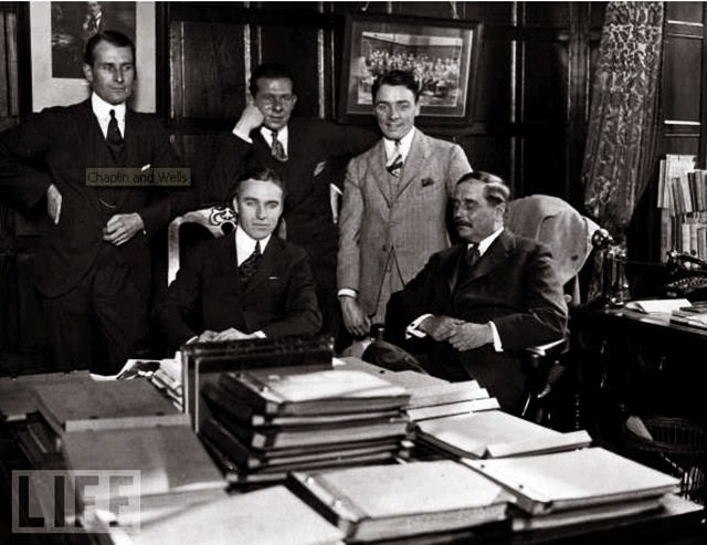 Novelist, short story writer, and historian H.G. Wells (right) with Chaplin (seated) and friends.