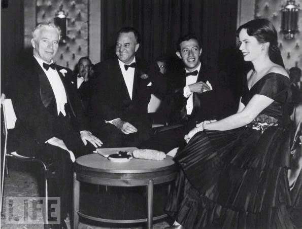 From left to right: Chaplin; newspaper columnist Harry Crocker; songwriter Adolf Green and Chaplin's new bride, Oona O'Neill at Charlie and Oona's wedding reception in 1943.