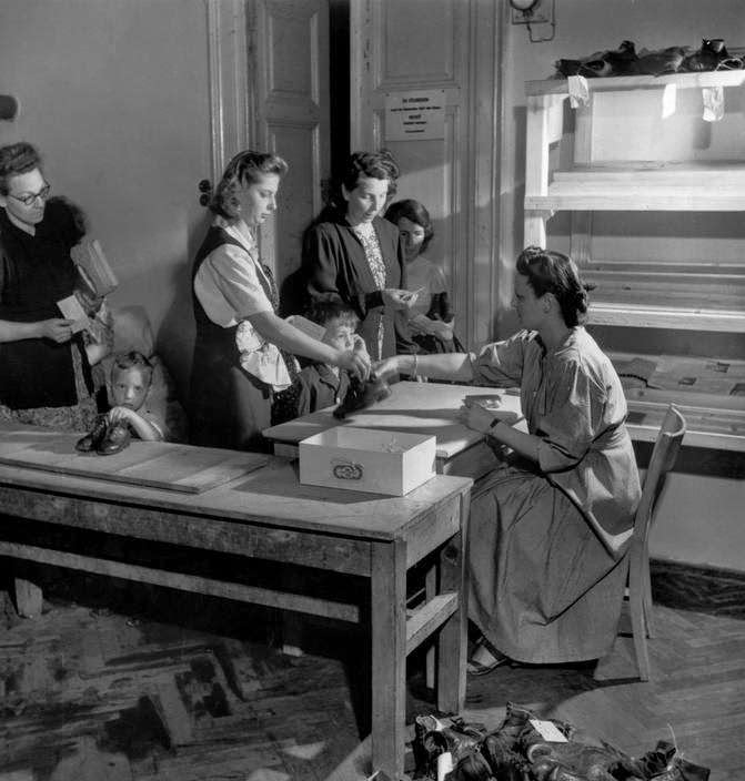 Children sharing shoes due to an acute leather shortage in Vienna, 1948