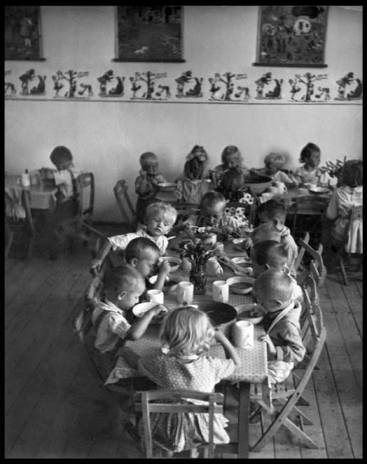 Village children eating a noon meal at a community kindergarten in Pilis, 1948