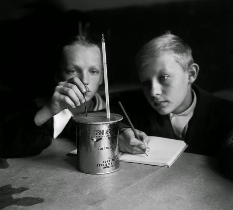 Students performing an oxygen experiment at a secondary school in Warsaw, 1948