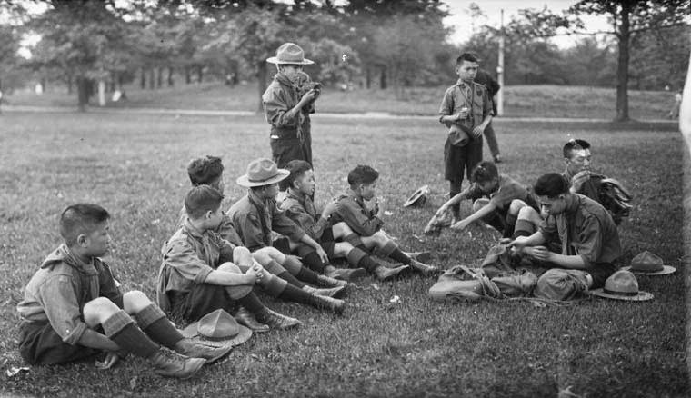 Chinese Boy Scouts eating lemons in High Park, Toronto, Ontario. June 8, 1919.