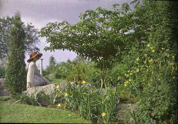 Woman on a rock in a garden, 1910s