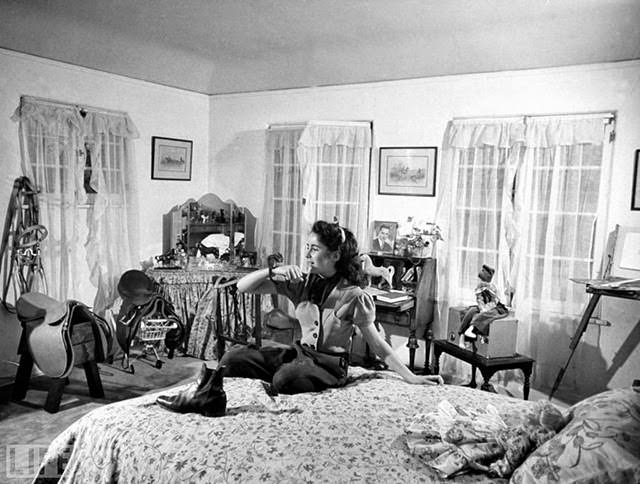 Taylor, age 13, in her bedroom with pet chipmunk Nibbles, 1945.