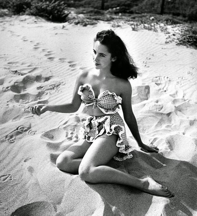 Elizabeth Taylor showing off, frilly two-piece bathing, 1947.