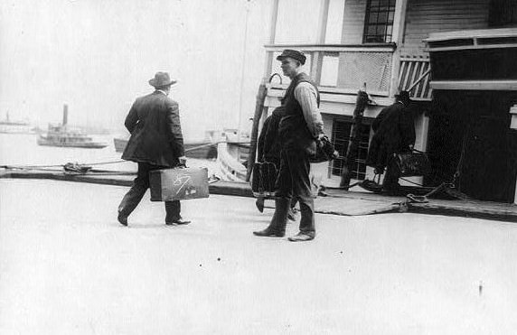 Immigrants boarding a ferry to Ellis Island, 1911