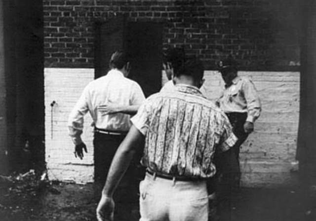 Elvis Presley arriving through the alley at the rear of the theater, 1956