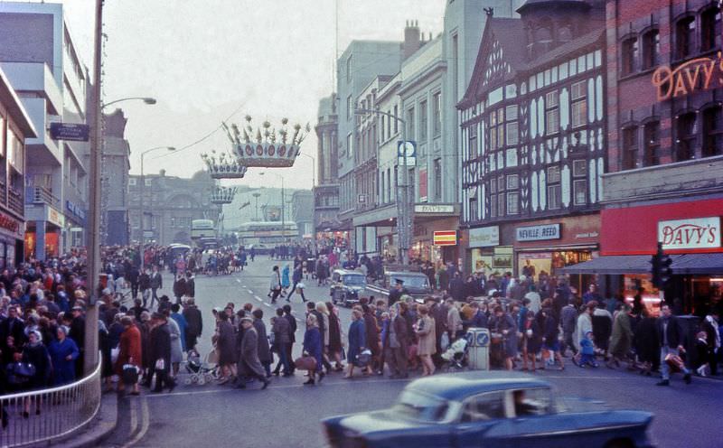 Crowds Christmas shopping under decorations in Haymarket, Sheffield, 1967