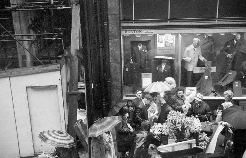 People clamoring to buy daffodils on a rainy day in Sheffield, 1968