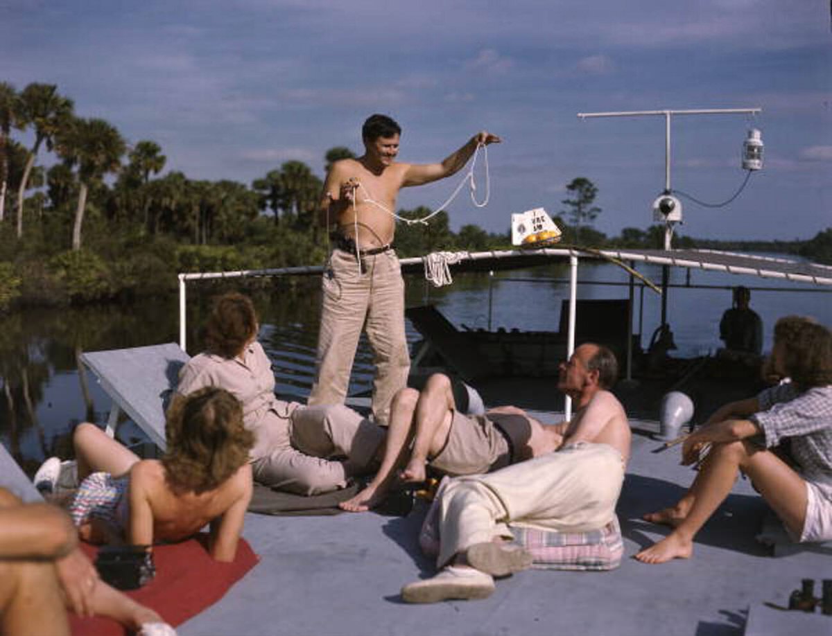 Joe Steinmetz performing a magic trick aboard the Lazy Bones shantyboat, 1940s