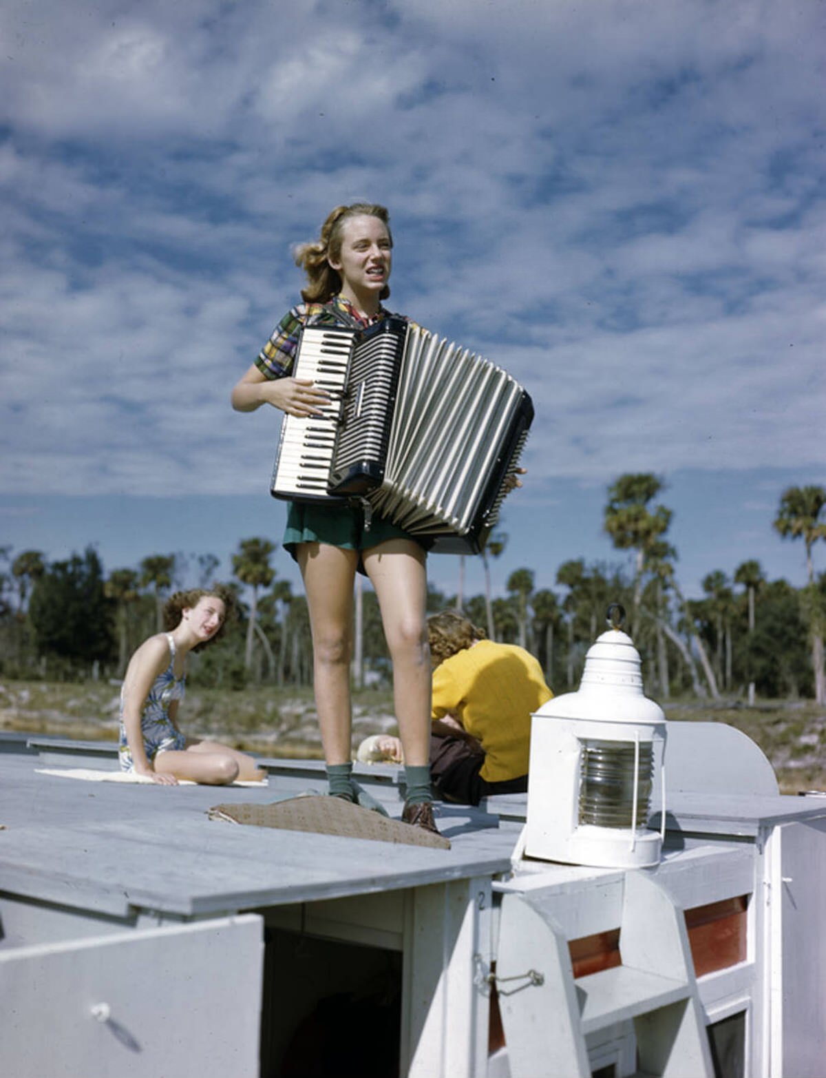 Lois Duncan Steinmetz playing the accordion aboard the Lazy Bones shantyboat, 1940s