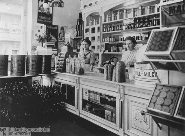 A well-ordered grocery store, 1913. By the early twentieth century, Germany was a highly industrialized country. A consumer society also developed. The shop in this photograph catered to the needs of German consumers. It offered whole milk, cocoa and chocolate, baked goods such as bread, packaged egg noodles, and bottled beverages.