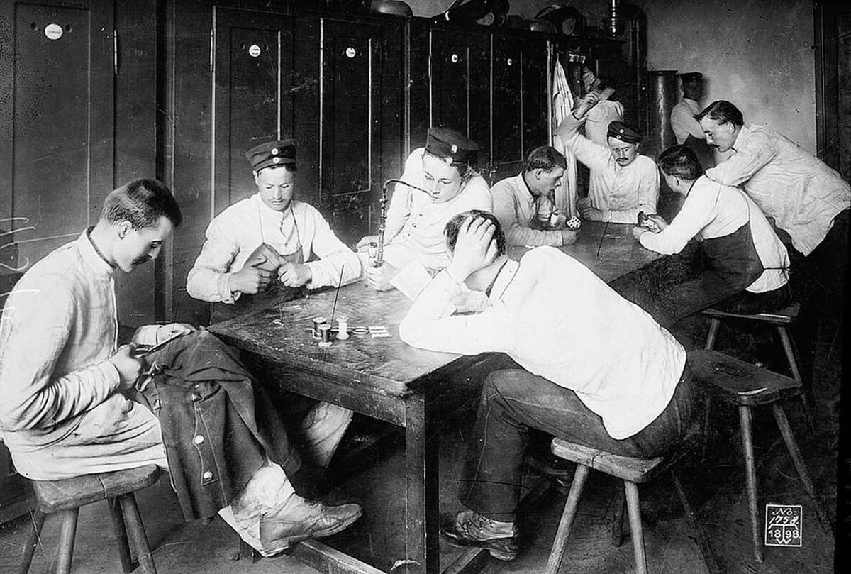 German Army soldiers in their barracks mending uniforms and playing cards, 1910s