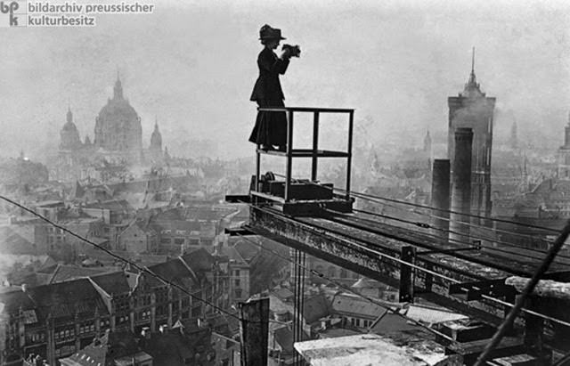 Women in journalistic professions were a rarity in Wilhelmine Germany. Nonetheless, some women did succeed in establishing themselves as journalists – initially, they did so by working for the women's newspapers and magazines that had been around since the middle of the nineteenth century; later on, they also worked for large newspapers. In this photograph (c. 1910), a female photographer surveys metropolitan Berlin from a crane being used in the construction of the Stadthaus [City Hall] on Molkenmarkt. The City Hall was built as an extension of the Rotes Rathaus [Red City Hall], whose large tower can be seen at the right. The Berliner Dom [Berlin Cathedral] can be seen in the background off to the left.