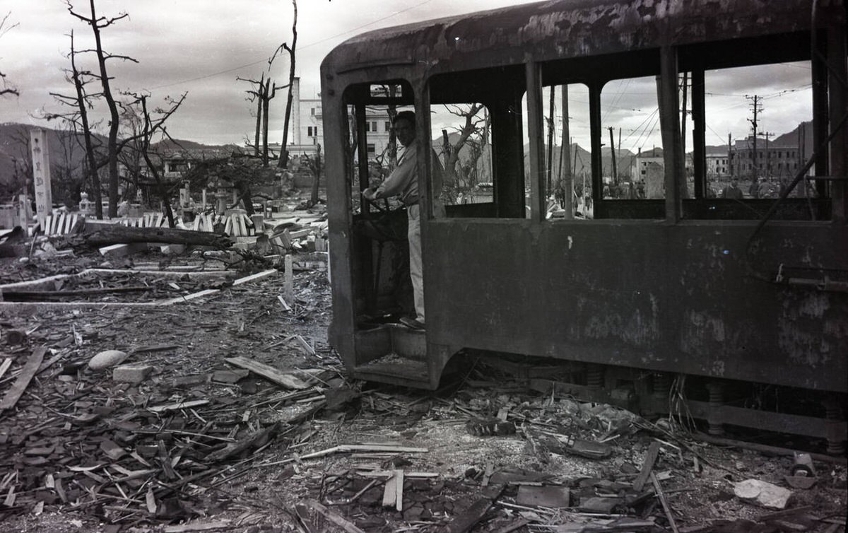 Soldier standing in a burned streetcar in the ruins of Hiroshima, 1945
