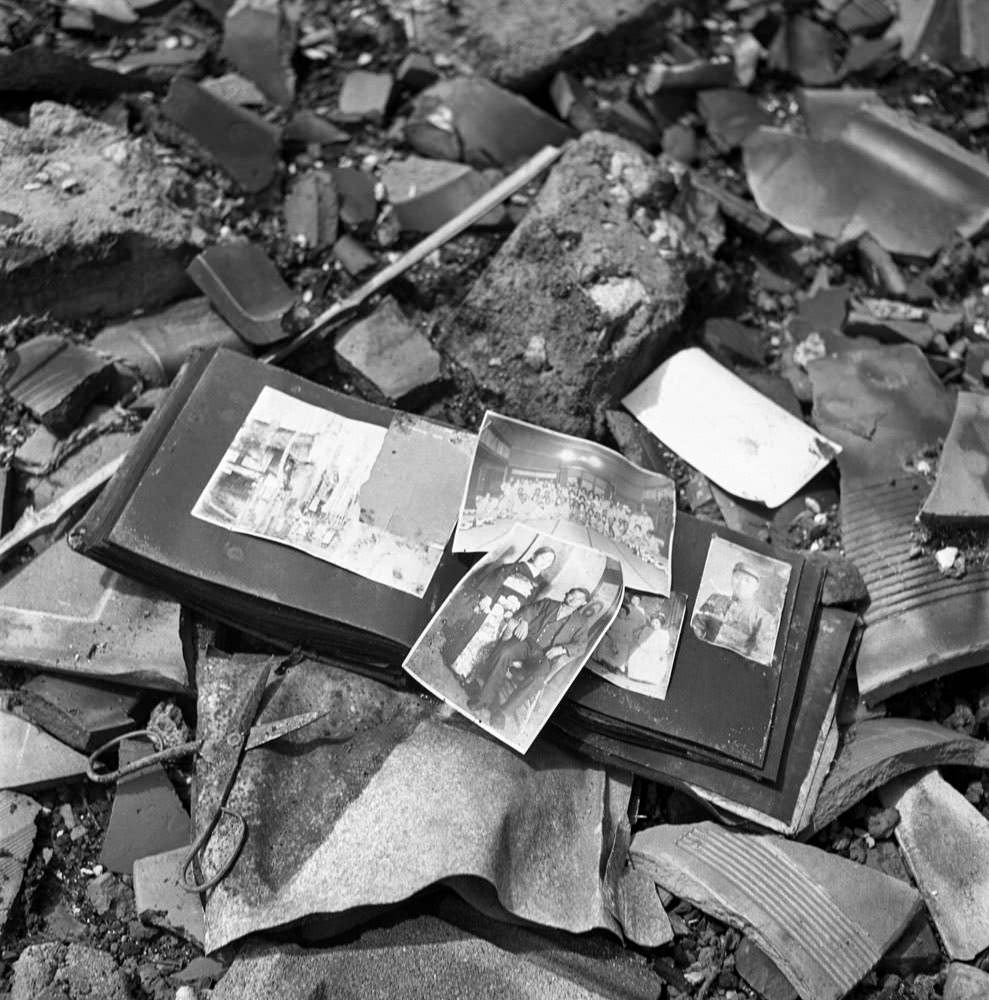 A photo album, pieces of pottery, a pair of scissors — shards of life strewn on the ground in Nagasaki, 1945.