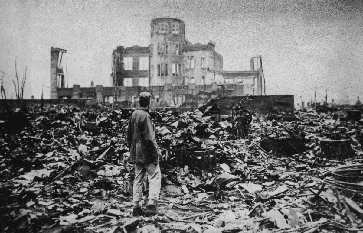 Soldier viewing the gutted remains of a theater in Hiroshima, 1950
