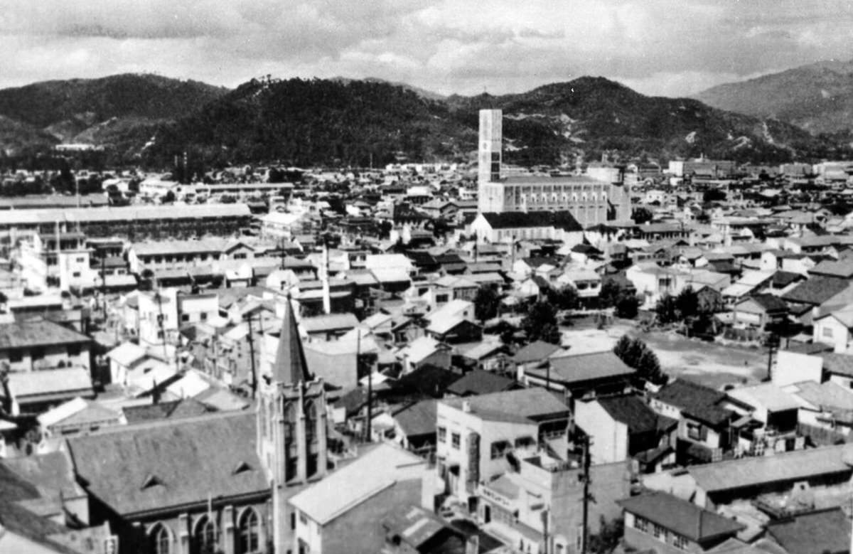 Rebuilt sections of Hiroshima with a surviving church in the foreground, 1954