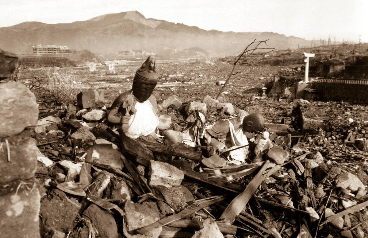 Battered religious figures on a hill above a tattered valley in Nagasaki, 1945