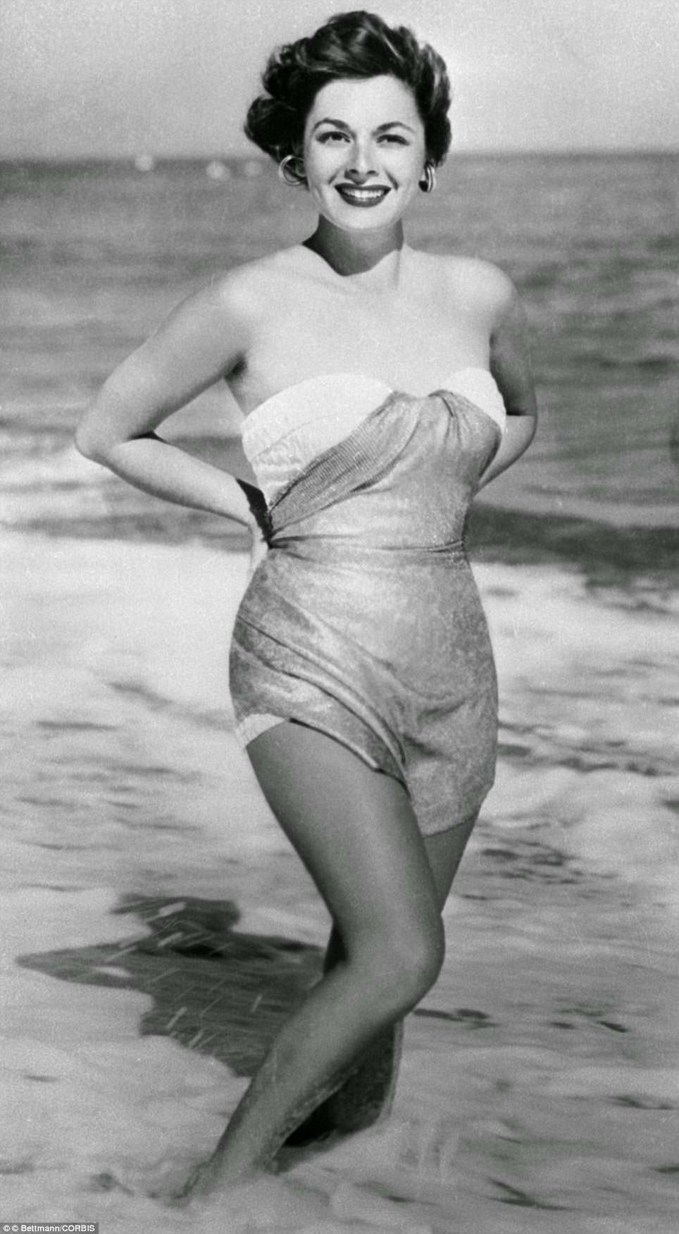 Ruth Roman paddling in the water, 1954