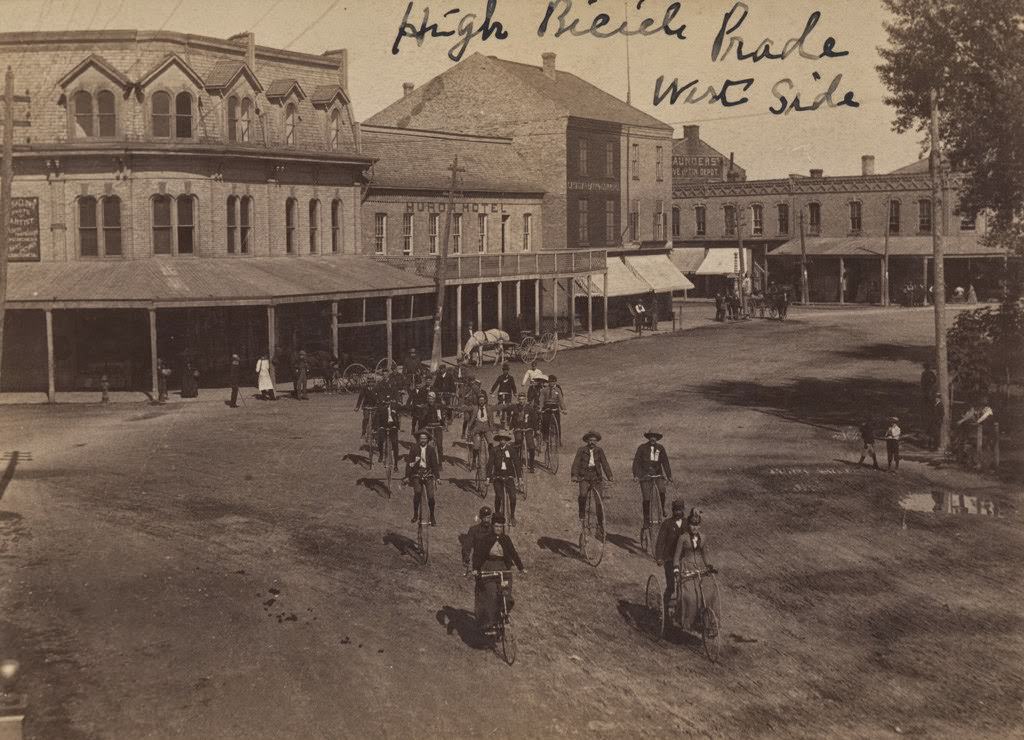 Parade of bicycles in a streetscape in Goderich, 1890s