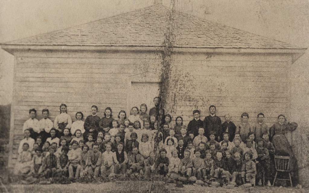 Group portrait of 81 students and teachers in front of the Dungannon School, 1890s