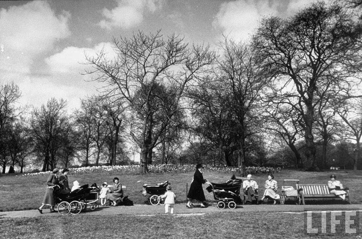 Woman walking their babies carriages and gossiping in Hyde park.