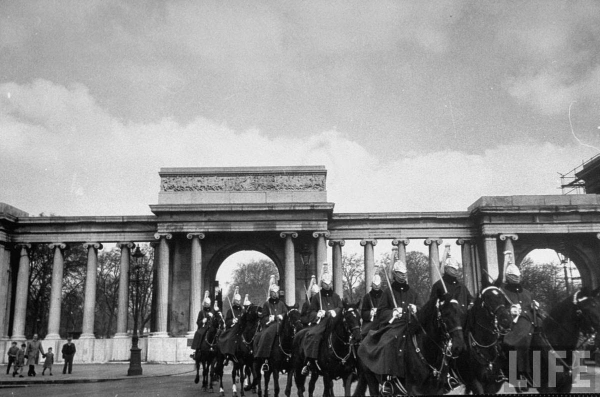 Great Britain's Army marching through the park on their horses.