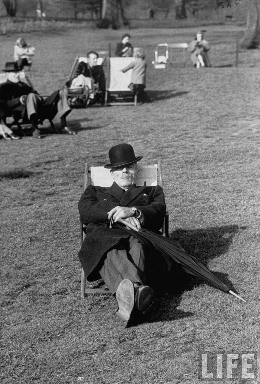A man taking a nap in the park on a lovely spring day.