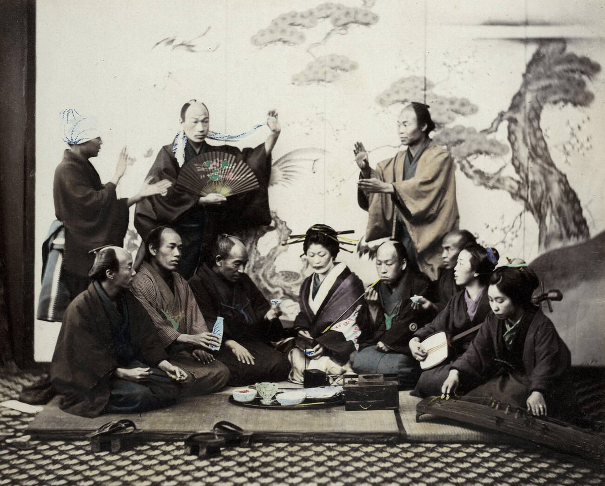 Group enjoying a social meal with music, dancing, and sake, 1860s