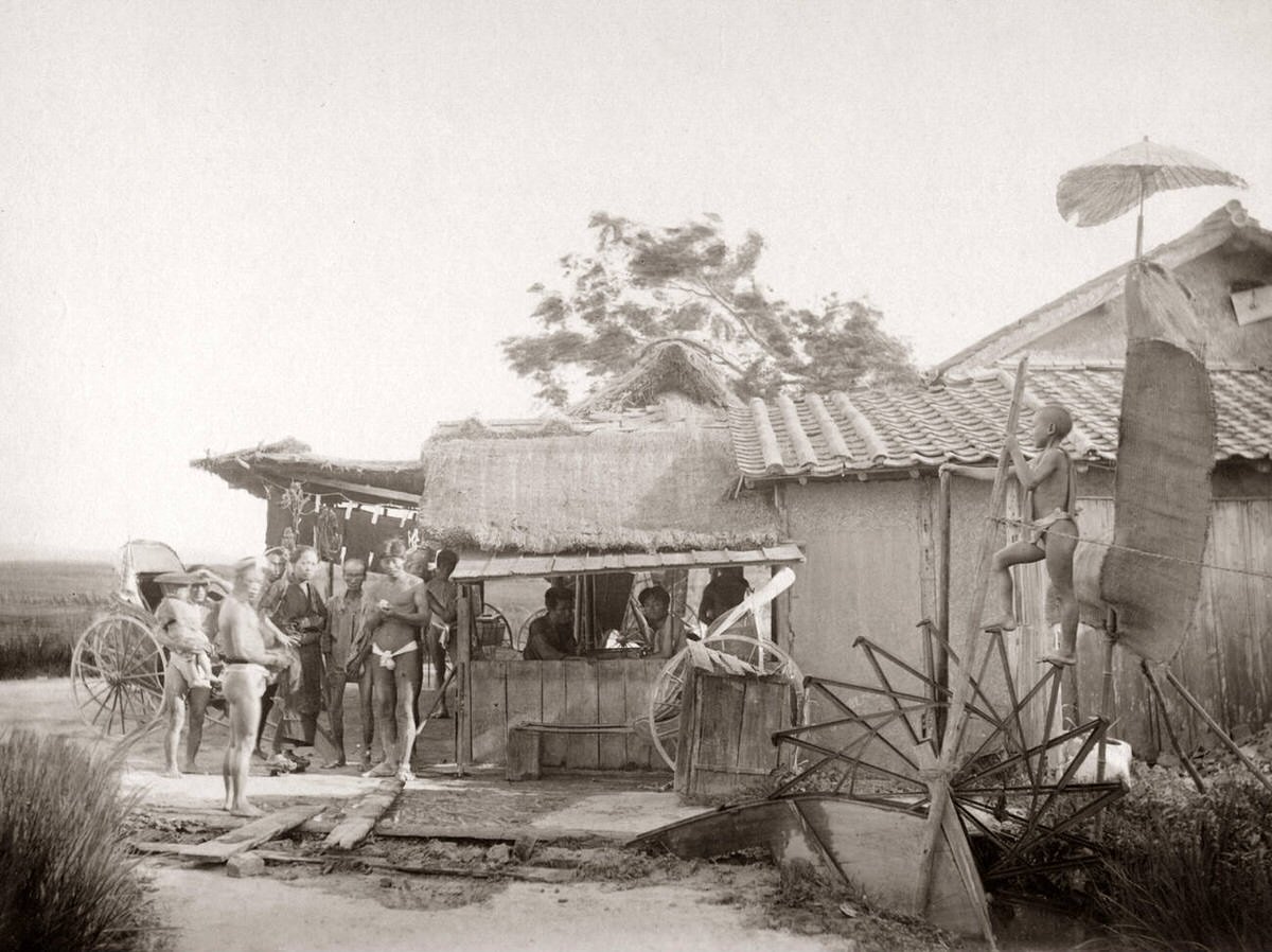 Water wheel irrigation and a roadside food stall in Japan, 1870s