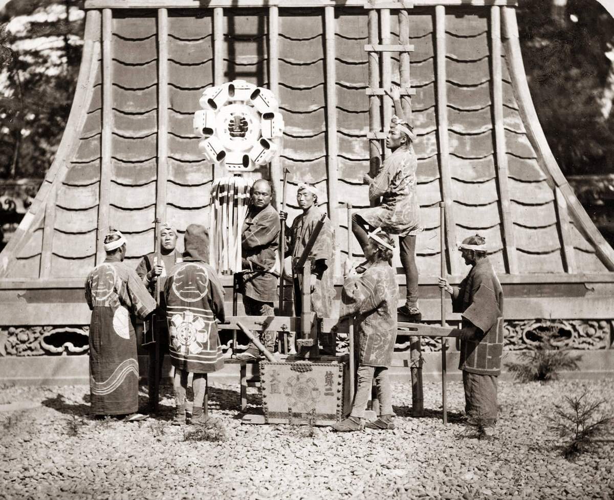 Japanese firefighters with a ladder and banner, 1880s