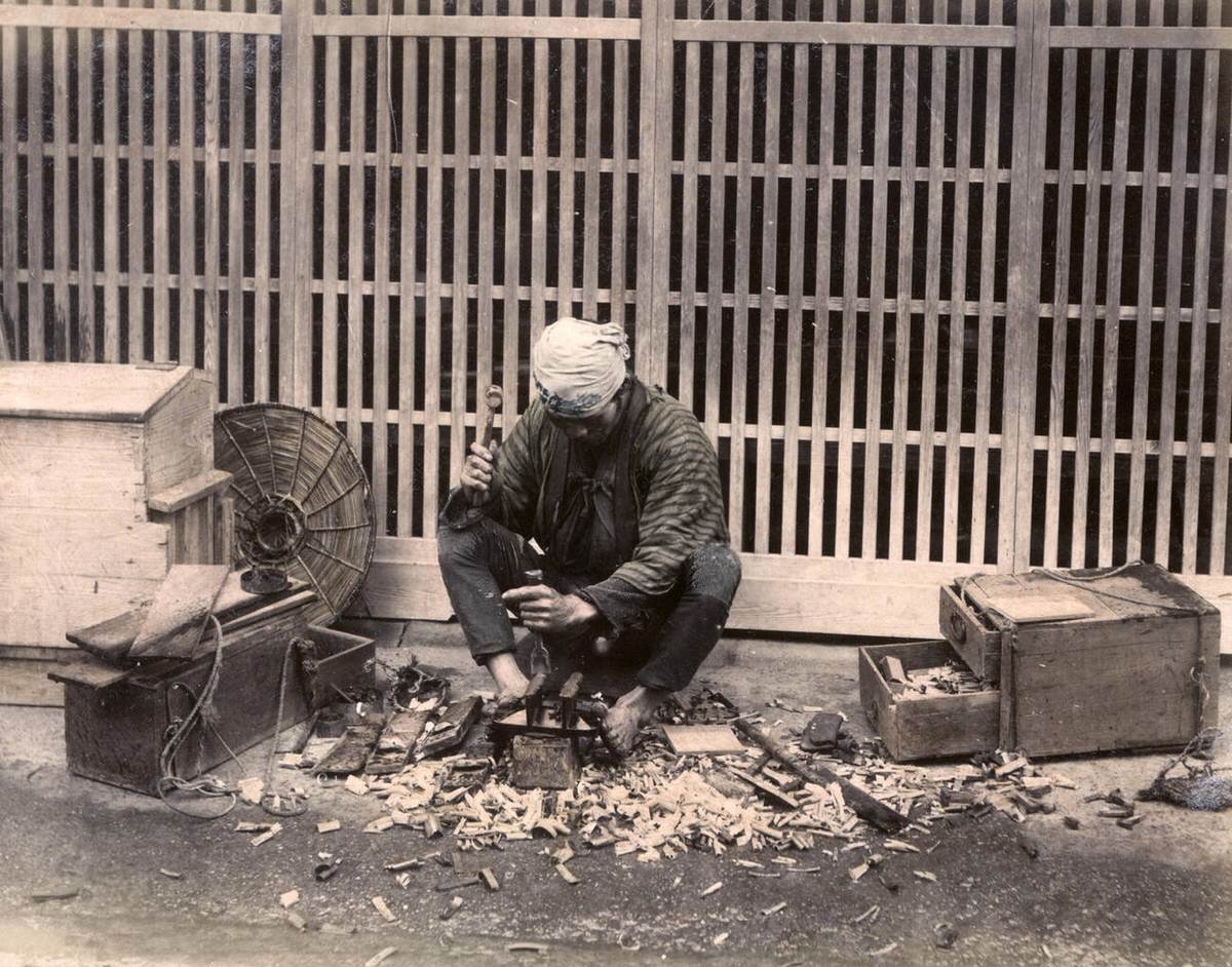 Carpenter with tools at work, 1880s