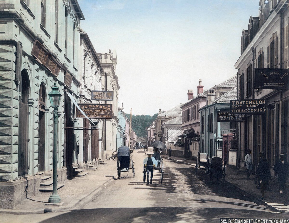 Rickshaw puller in front of shops on Honcho-dori in Yokohama, 1890s