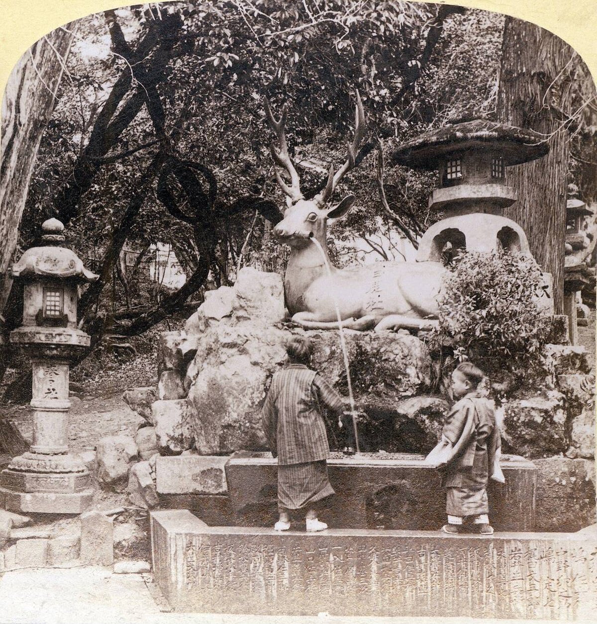Children at the deer fountain on the grounds of Kasuga Grand Shrine in Nara, 1890s